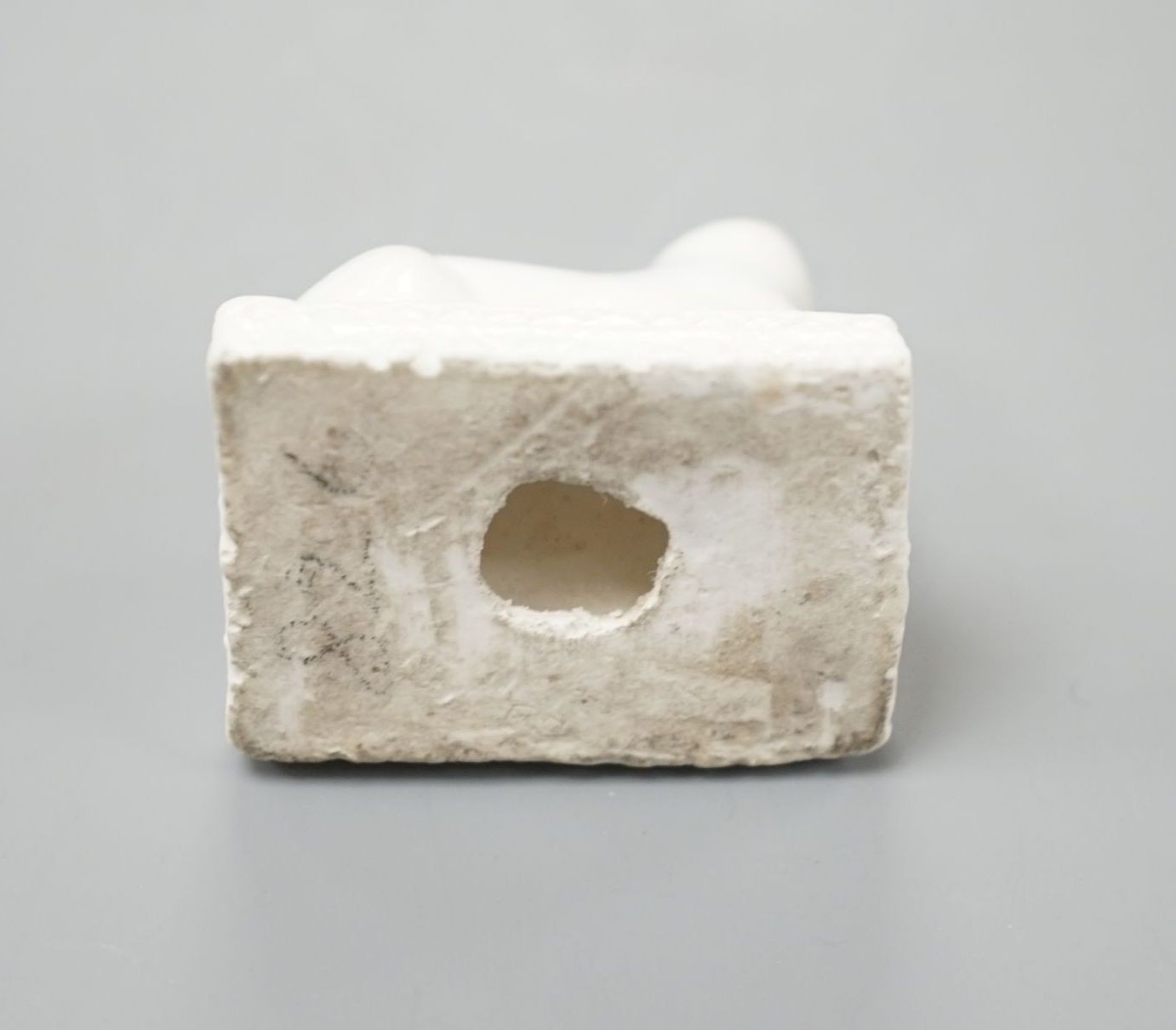 A Derby porcelain model of a cat recumbent on a cushion base, c.1810–25, 3.6 cm long, Cf. Dennis G.Rice, Cats in English porcelain, a variant of colour plate 21., Provenance: Dennis G.Rice collection